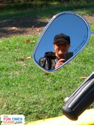 Here I'm taking a selfie while looking into the side view mirror on our motorcycle. 